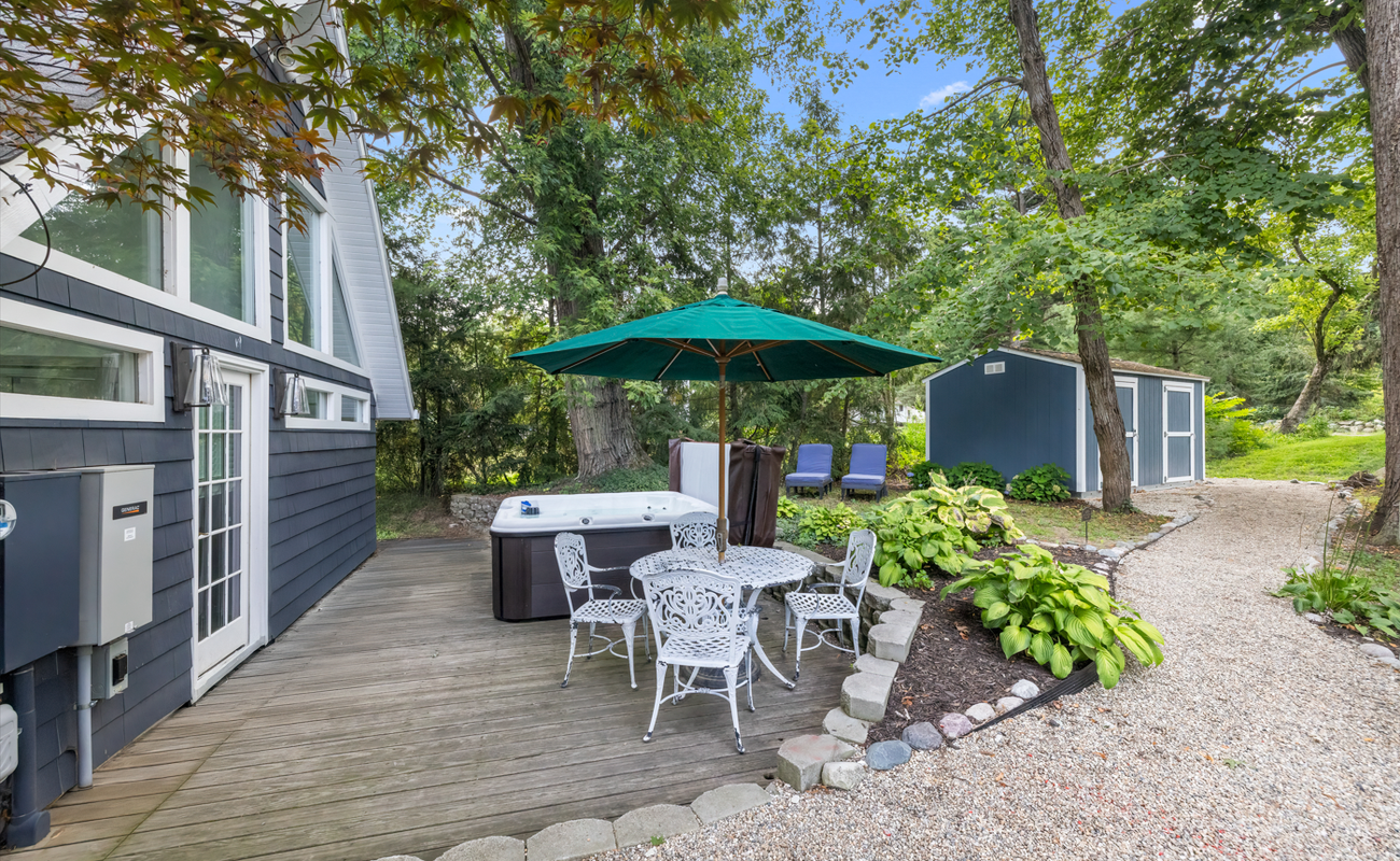 Serene deck escape with spa and shaded seating.