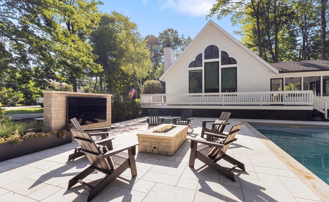 Light up the night with poolside fire pit fun.