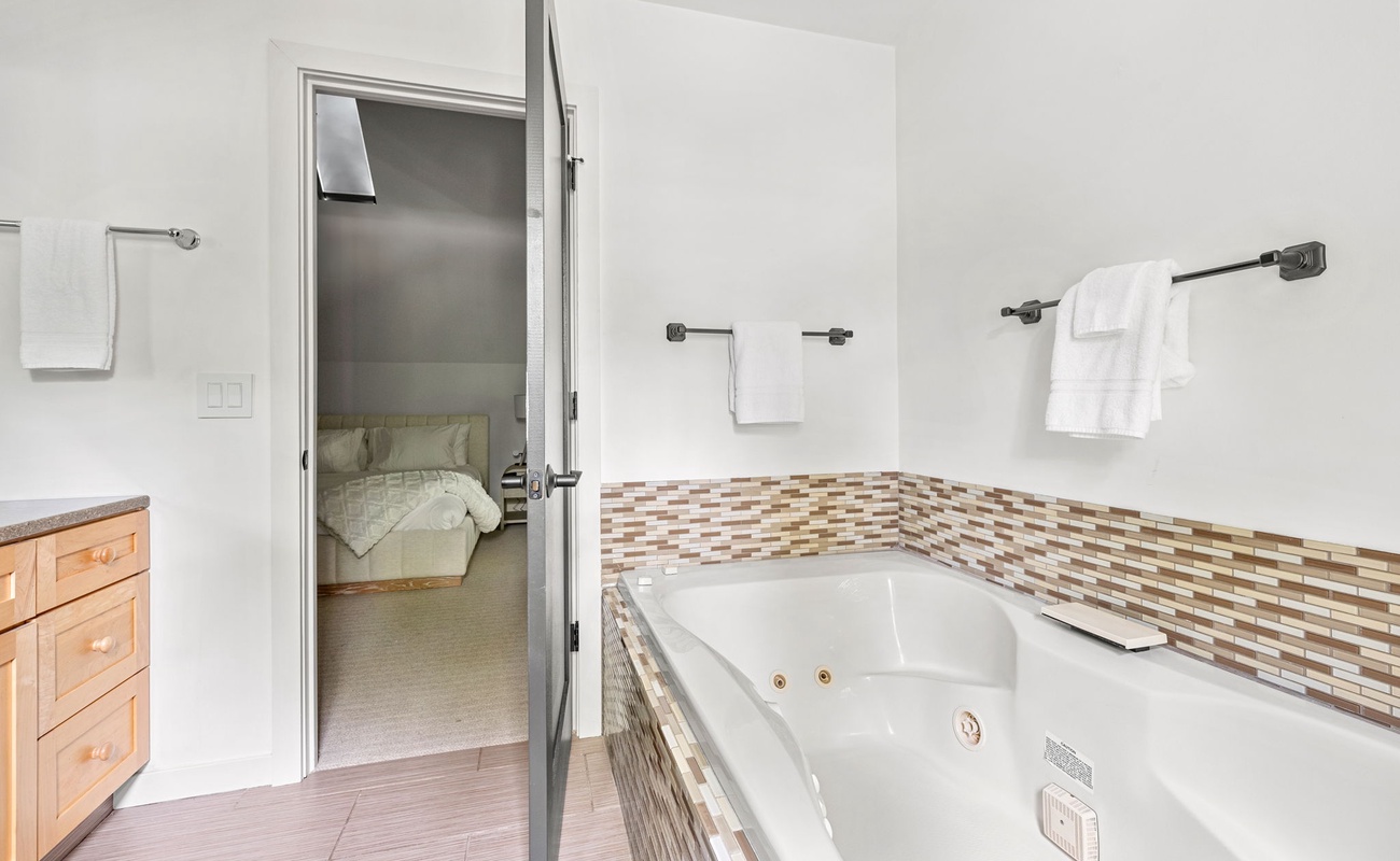 A tub that’s ready to melt away your stress—right next to your cozy retreat.