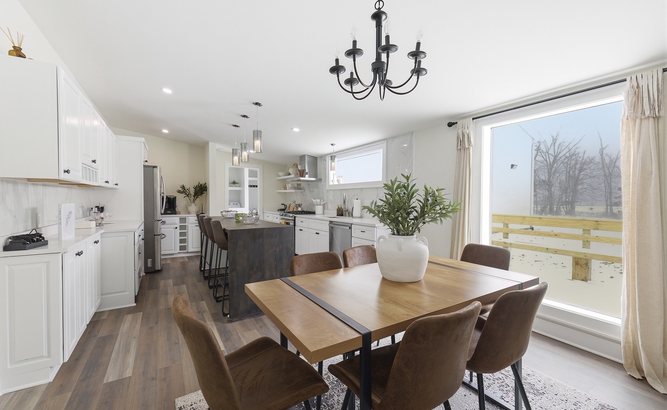 Dining for six beside the kitchen, with island seating just beyond.
