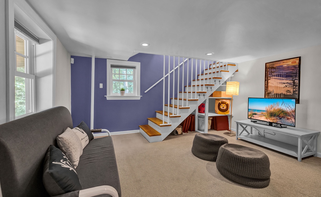 A fun lower-level hangout with TV, games, and bold color.