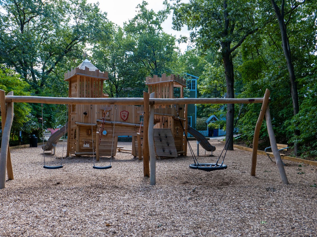 Let kids climb, swing, and explore at Beachwalk’s wooded playground.
