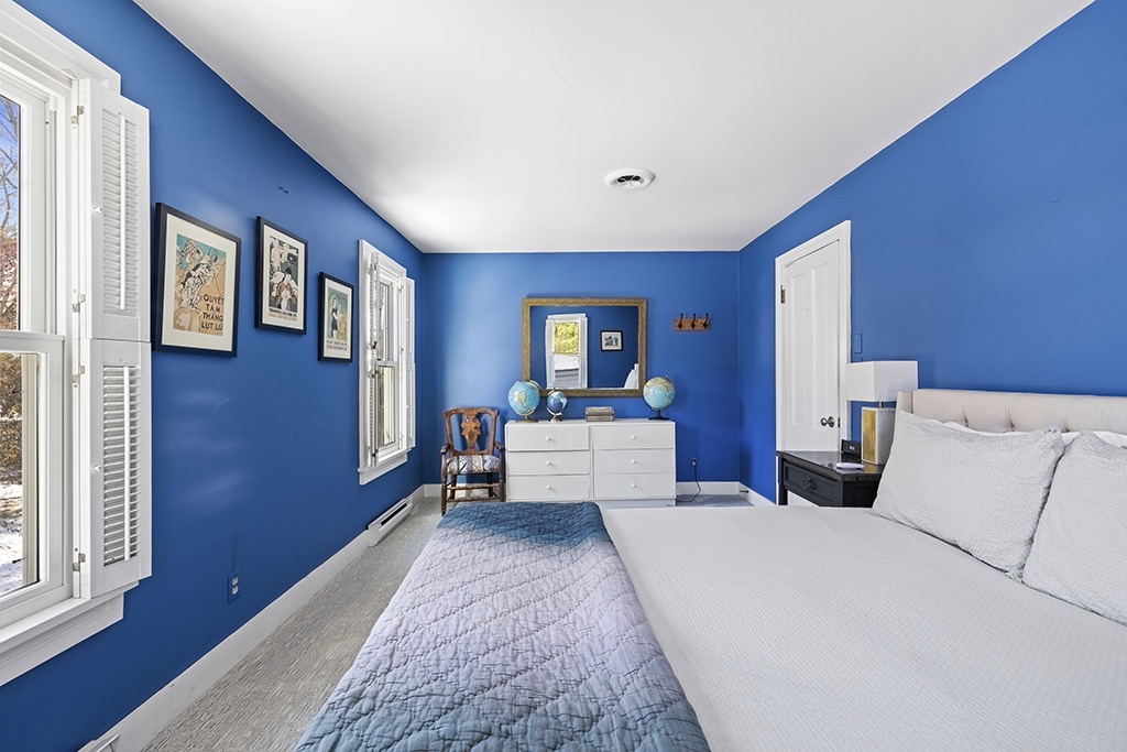 Bedroom 4 in The Farmhouse is on the upper level and has a queen-size bed.