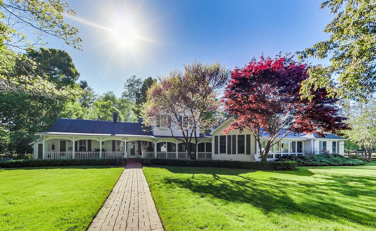 The Farmhouse glows at sunrise, inviting you into pure country calm.