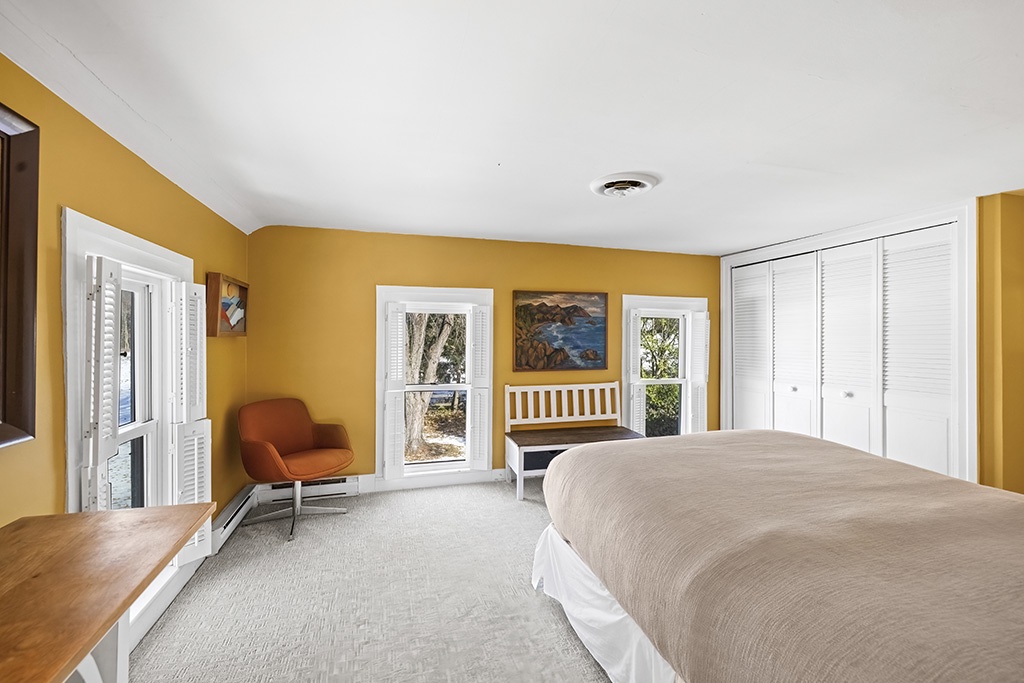 A bright, inviting bedroom where golden light fills every corner.