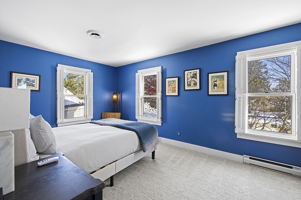 Sun-filled blue bedroom offering calm mornings at The Farmhouse.