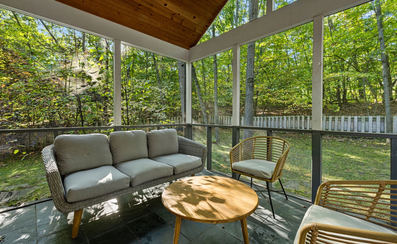 The screened-in porch features outstanding woodland views, including at sunset.