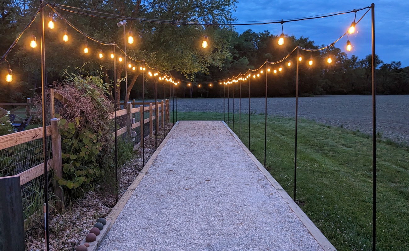 Evening bocce under twinkling lights at Berrywood Farm.