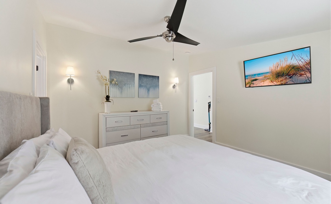 This bedroom gives guests extra space and a television of their own.