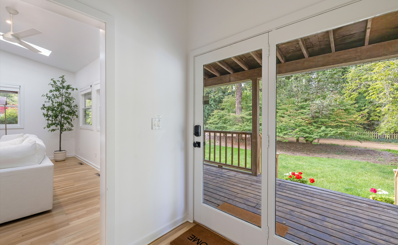 This sunlit entryway opens to a charming porch.
