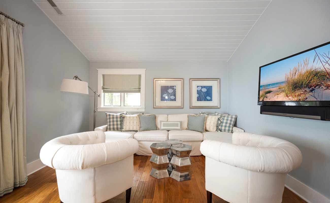 The Master Bedroom features a sweet den with comfy seating and a flat-screen TV.