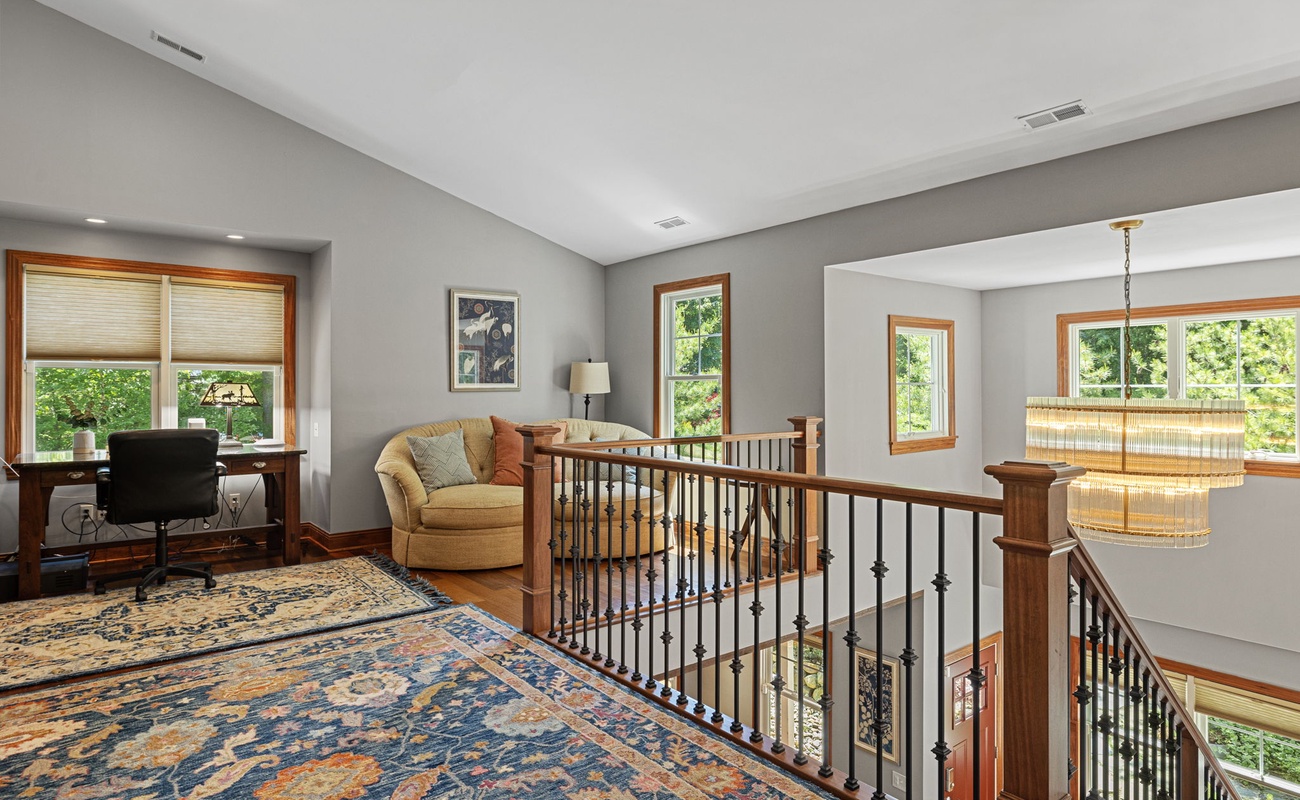 Virtual commuters will appreciate this well-lit workspace in the loft.