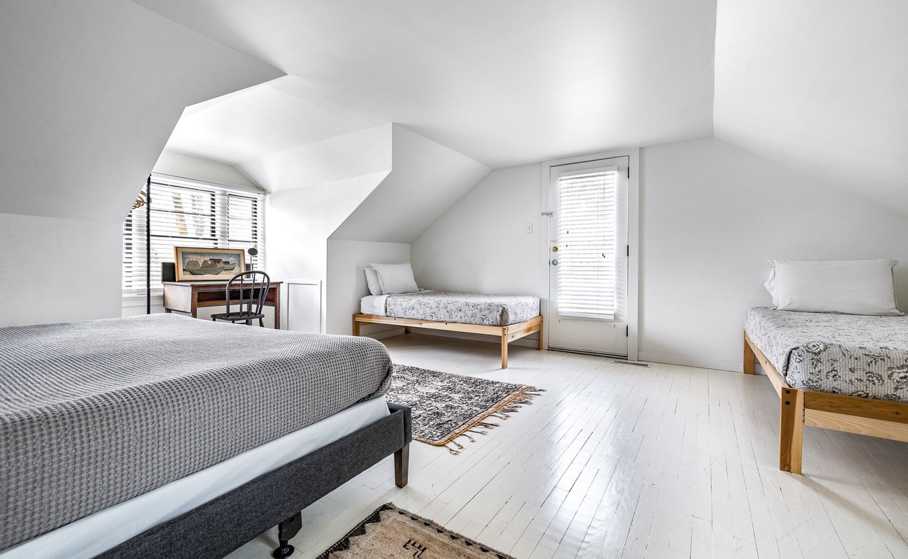 A triple threat of beds, light, and attic charm. Weekend retreat, anyone?