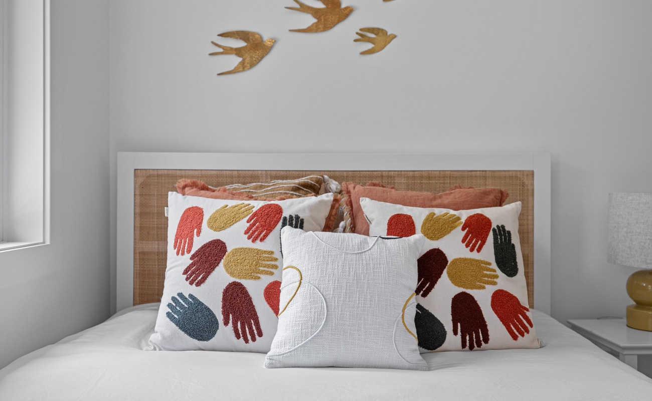 Sink into comfort and relaxation with this inviting bed, surrounded by plush pillows.