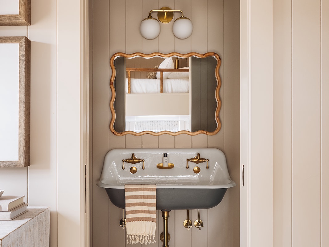 This Ensuite bathroom features a twin-fixtures sink and gorgeous decor details.