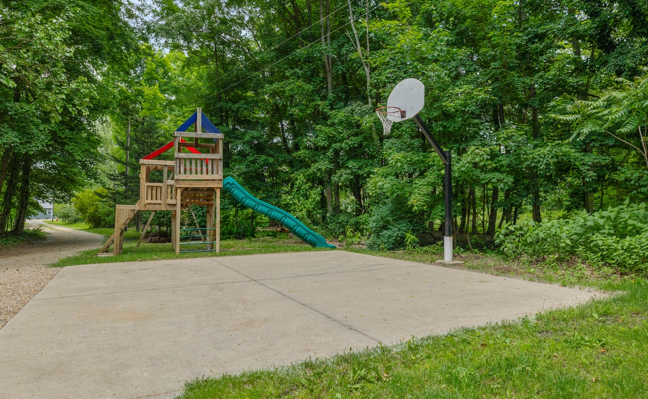 Shoot hoops or slide into fun—backyard play at its finest.