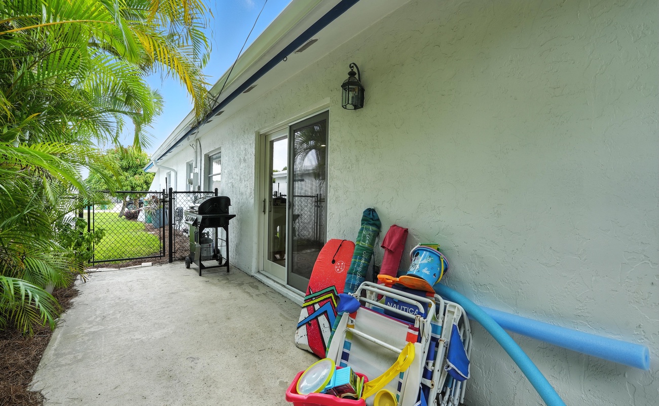Beach day made easy with chairs, toys, and grill at the ready.