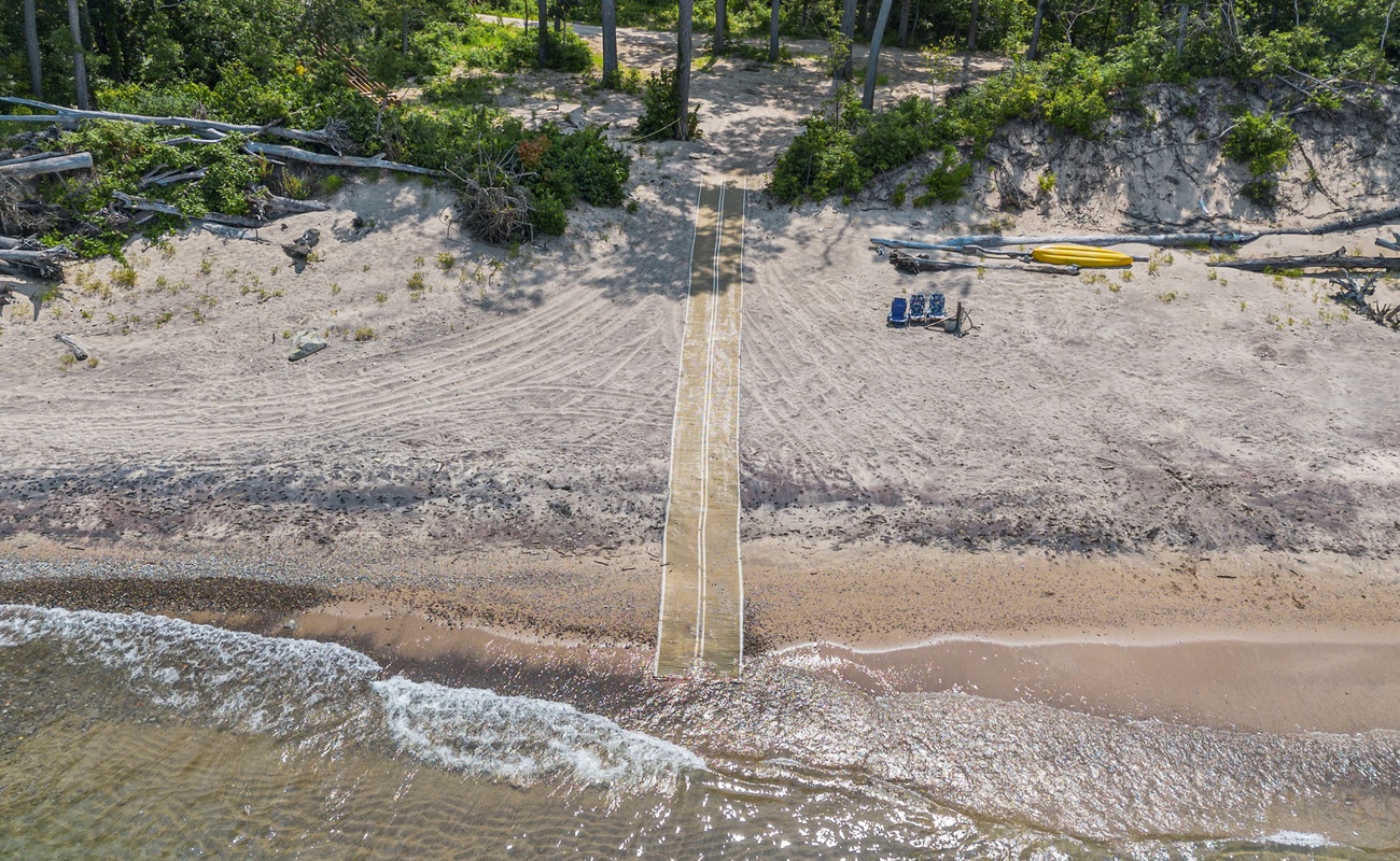 Adventure awaits down this sandy path.