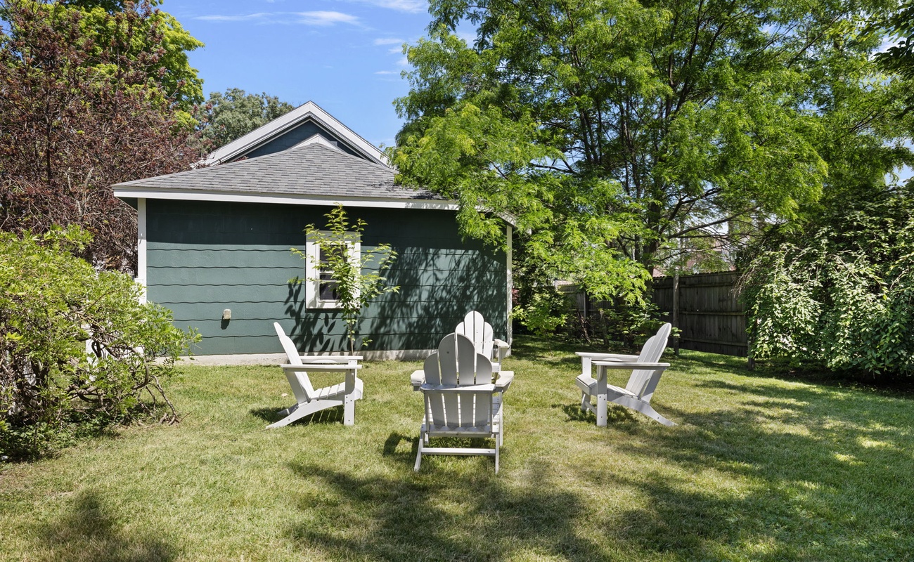 Chillin' in this backyard paradise, where the grass is always greener and the chairs are always ready for a fireside chat!