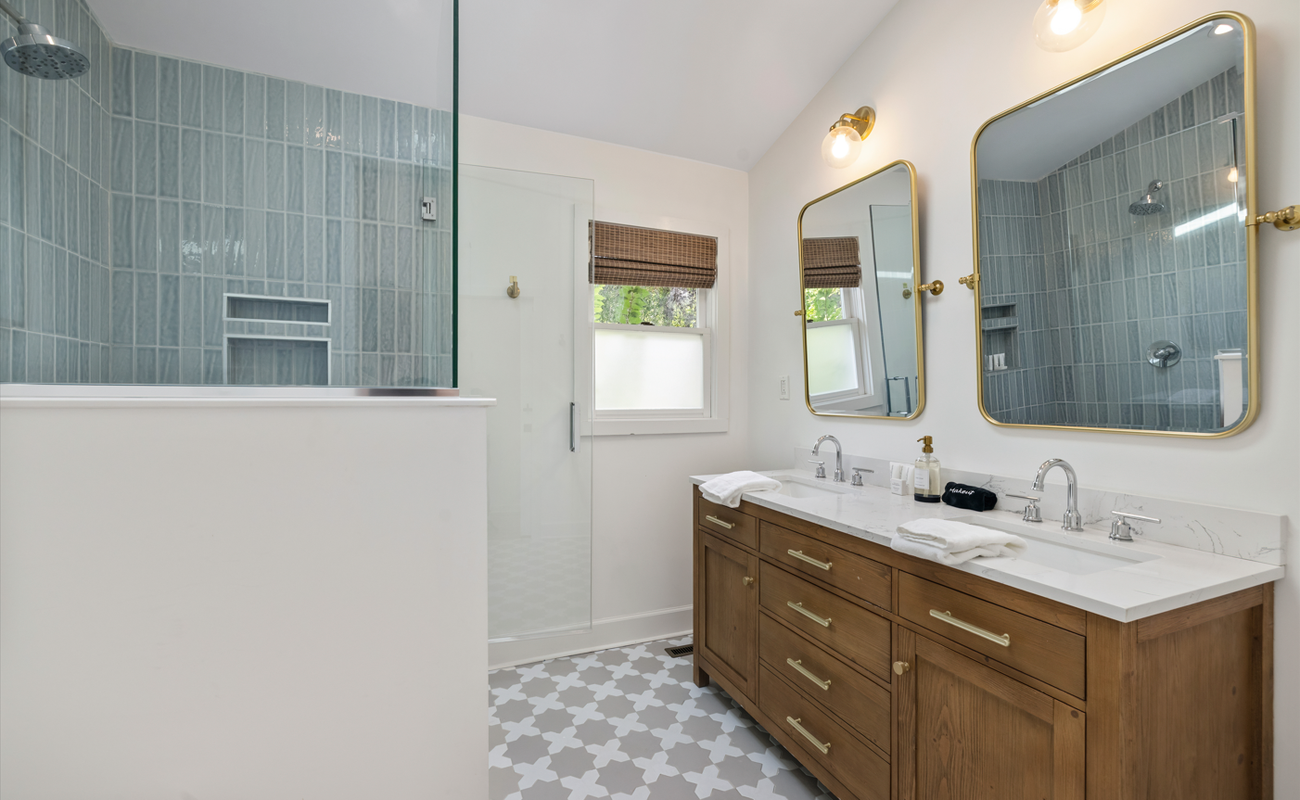 Luxe green tile, gold accents, and all the space you need to unwind and glow.