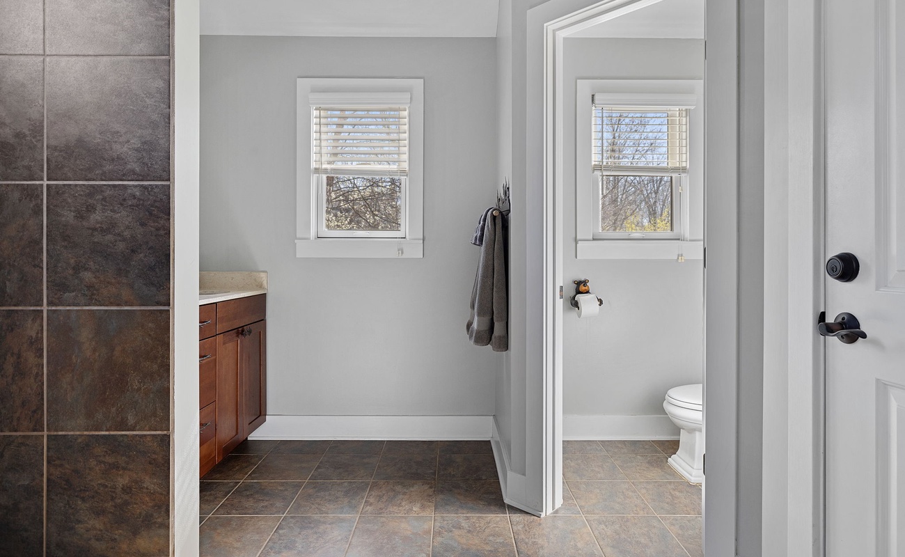 Loving this bathroom's appealing use of tile and its stone-top vanity cabinet.
