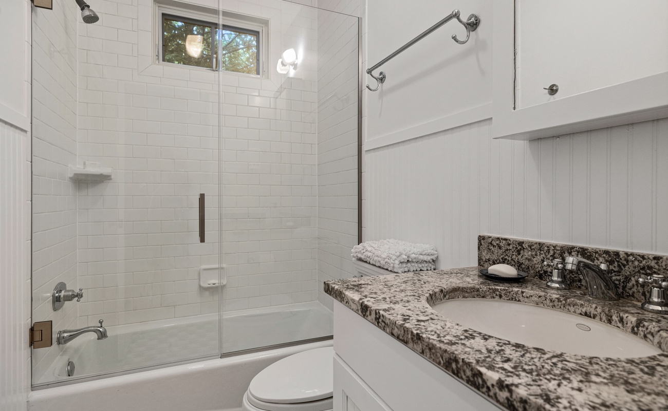 Our full bath features a granite-topped sink and tiled shower.