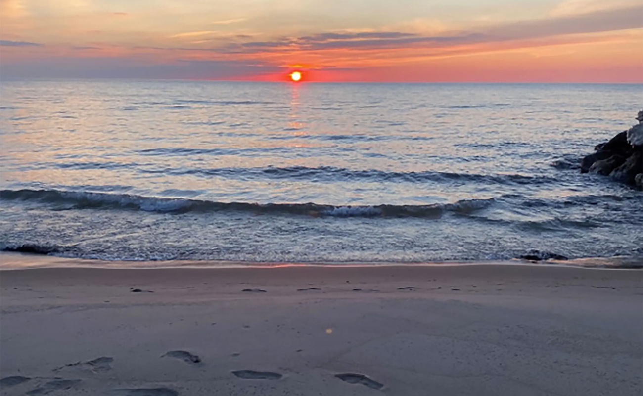 Enjoy calm evening walks along our beach as the sun sets over Lake Michigan.