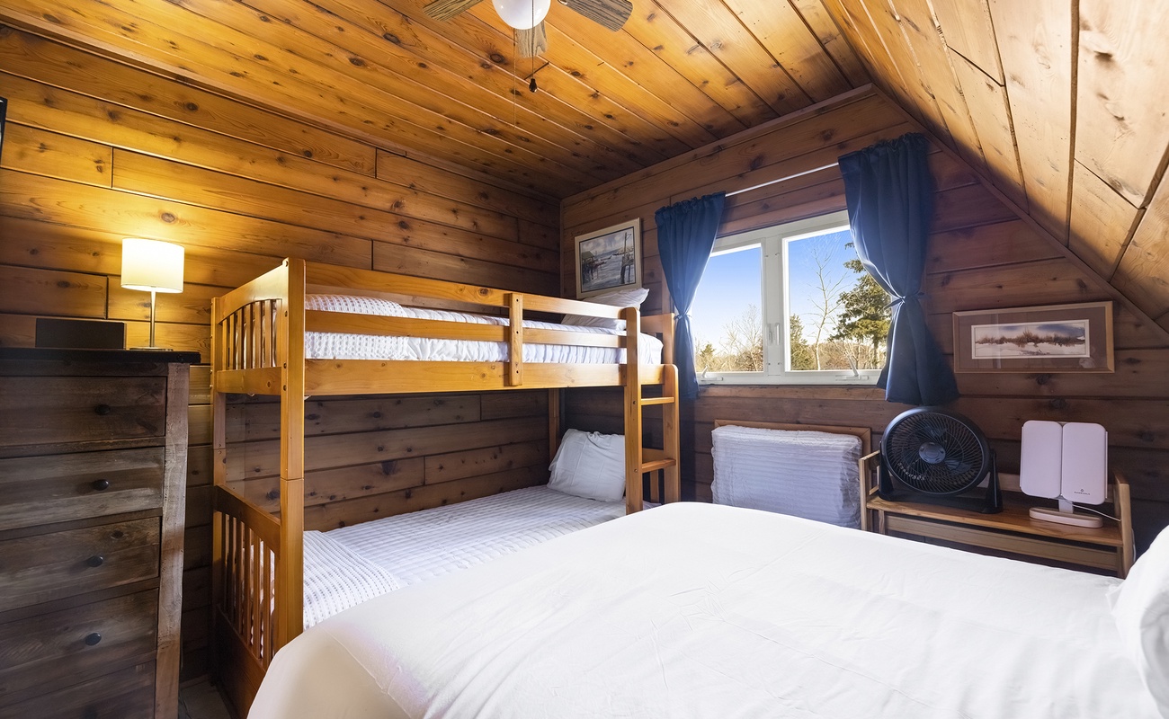 Relax and unwind in this bright bedroom after a day outdoors.