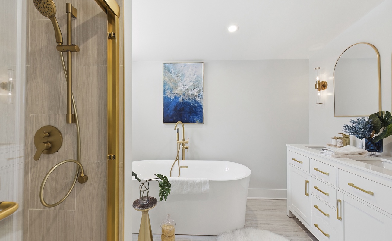 Indulge in a spa experience with a deep soaking tub and gold finishes.