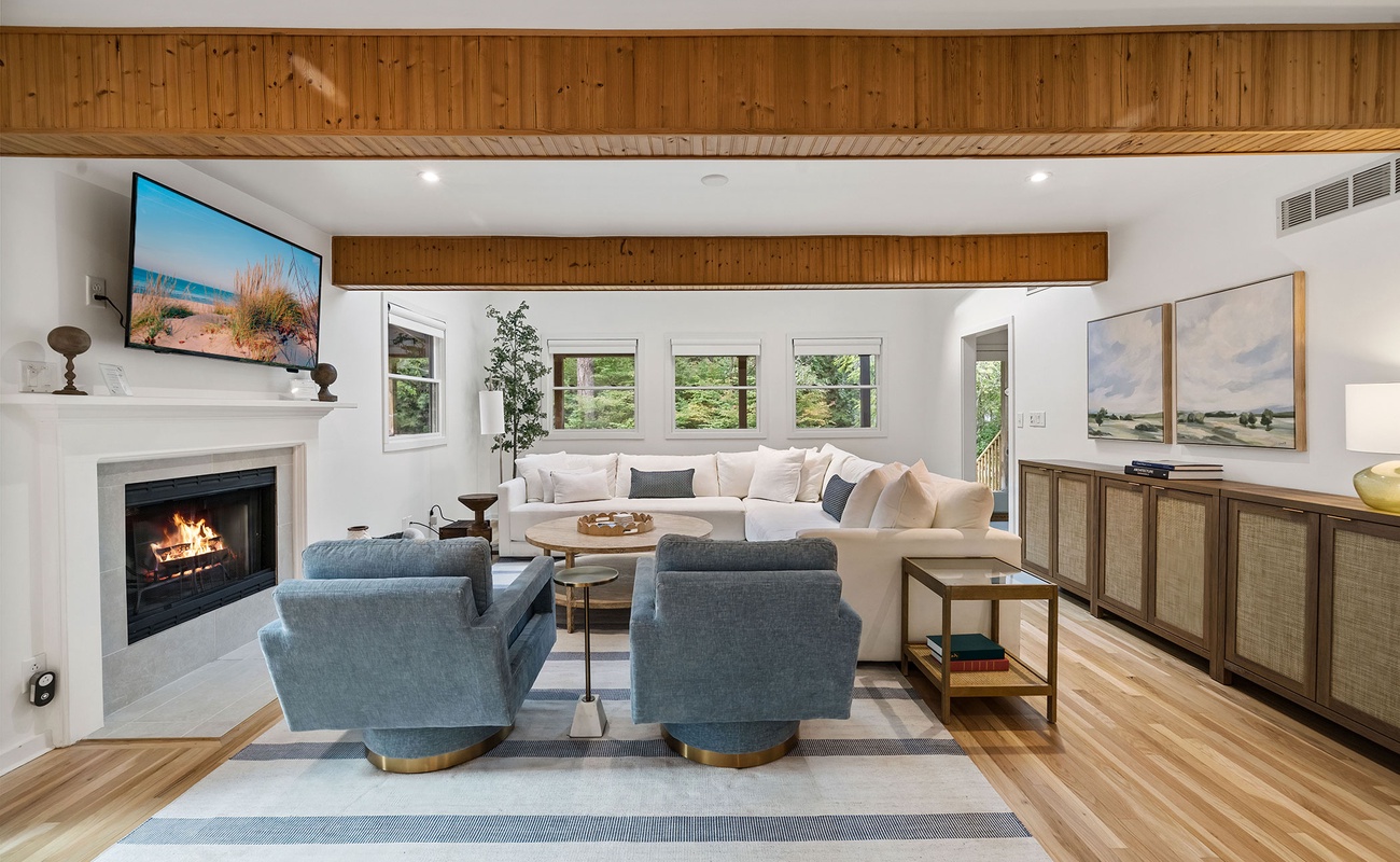 Soak up the sun and good vibes in this bright and airy living room. Complete with vaulted ceilings, skylights, and the comfiest sectional for ultimate lounging!
