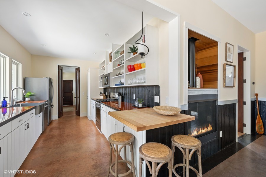 The butcher-block breakfast nook with barstools is a great spot for enjoying a quick cup of coffee before heading out to explore the area.