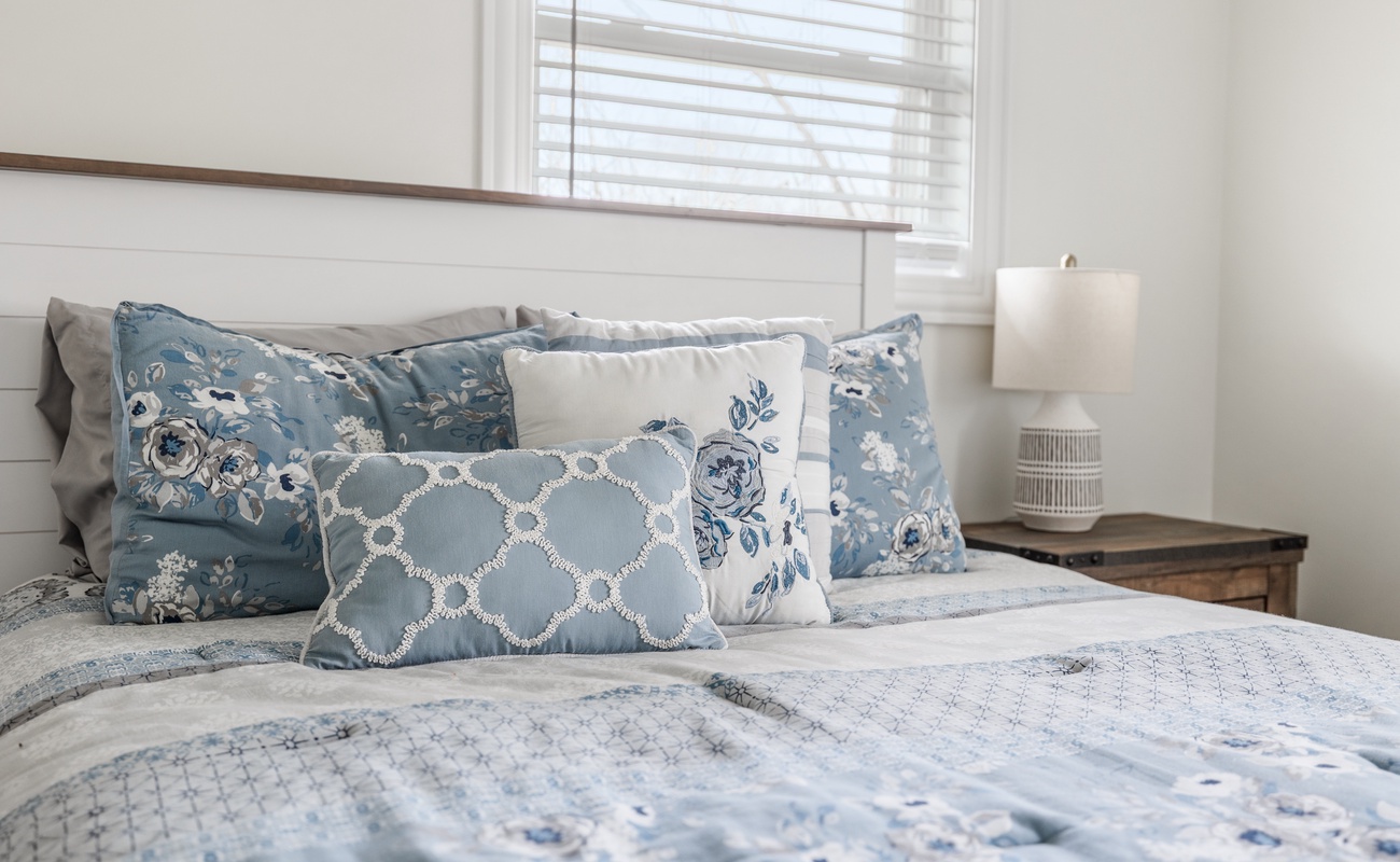 Soft pillows, cozy textures, and a soothing blue palette designed for comfort.