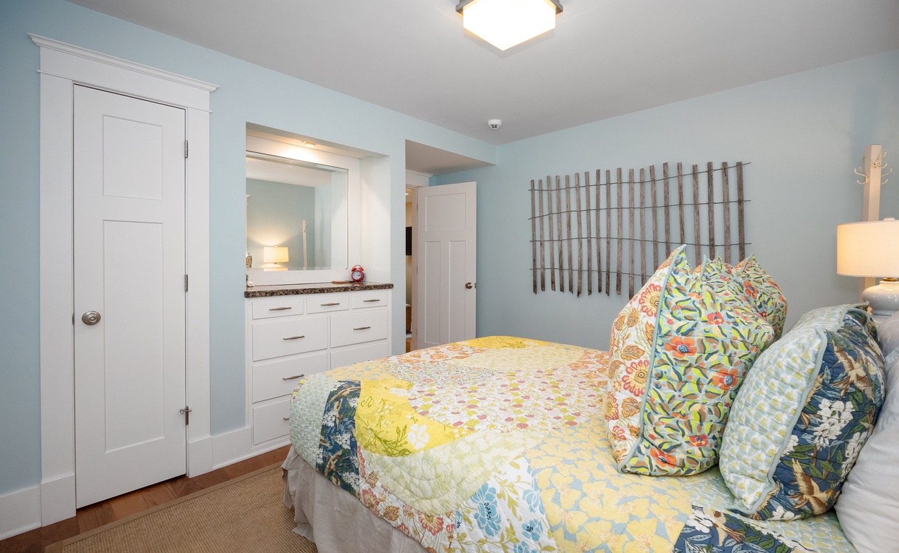 This cozy bedroom shares access to a sitting room that has a comfy sofa-bed.