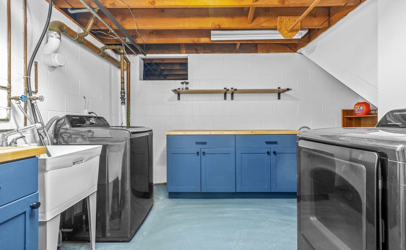 Bright, spacious laundry area with modern machines and bold style—chores made easy.