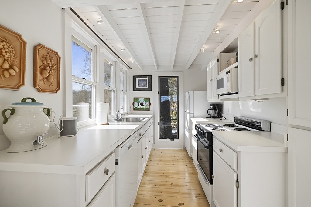 Sunlight warms The Cottage's kitchen, perfect for simple home-cooked meals.