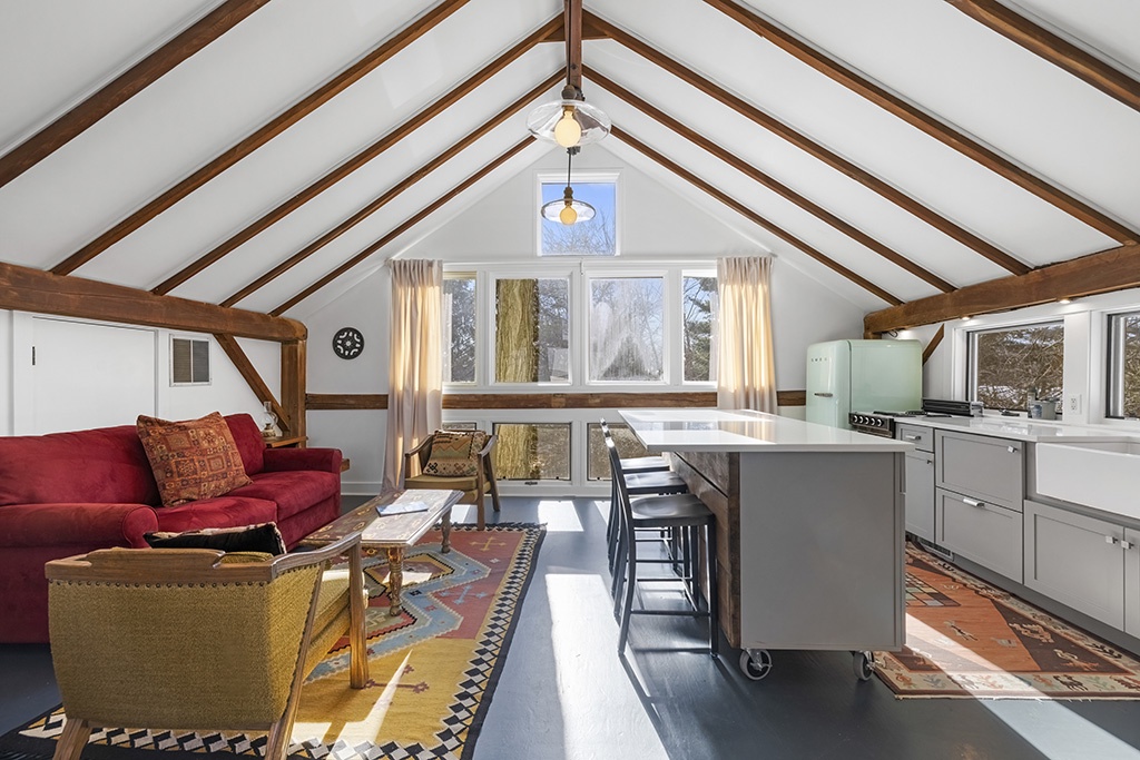 The Loft at Berrywood Farm with vaulted ceilings, retro kitchen, and inviting seating area.