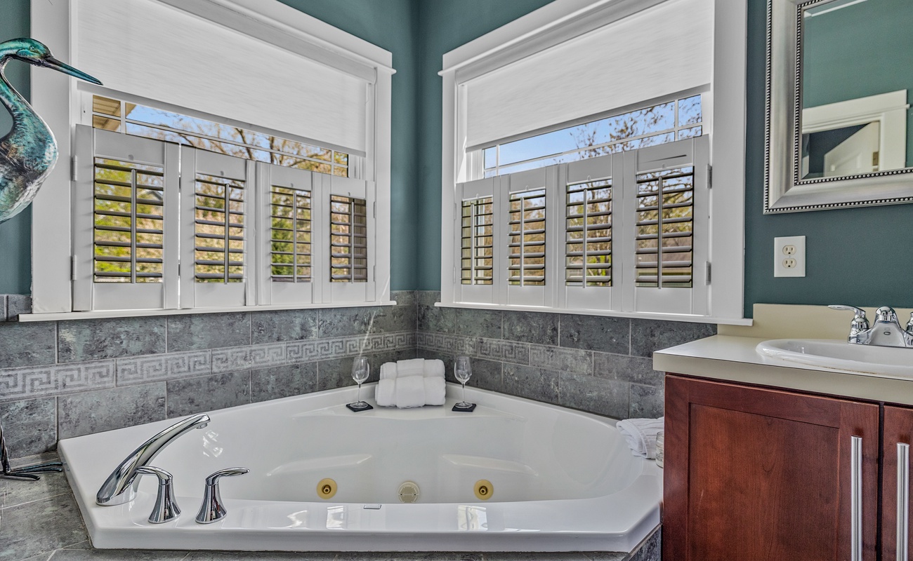 Deep soaking tub, sunlit views, and total relaxation on tap.