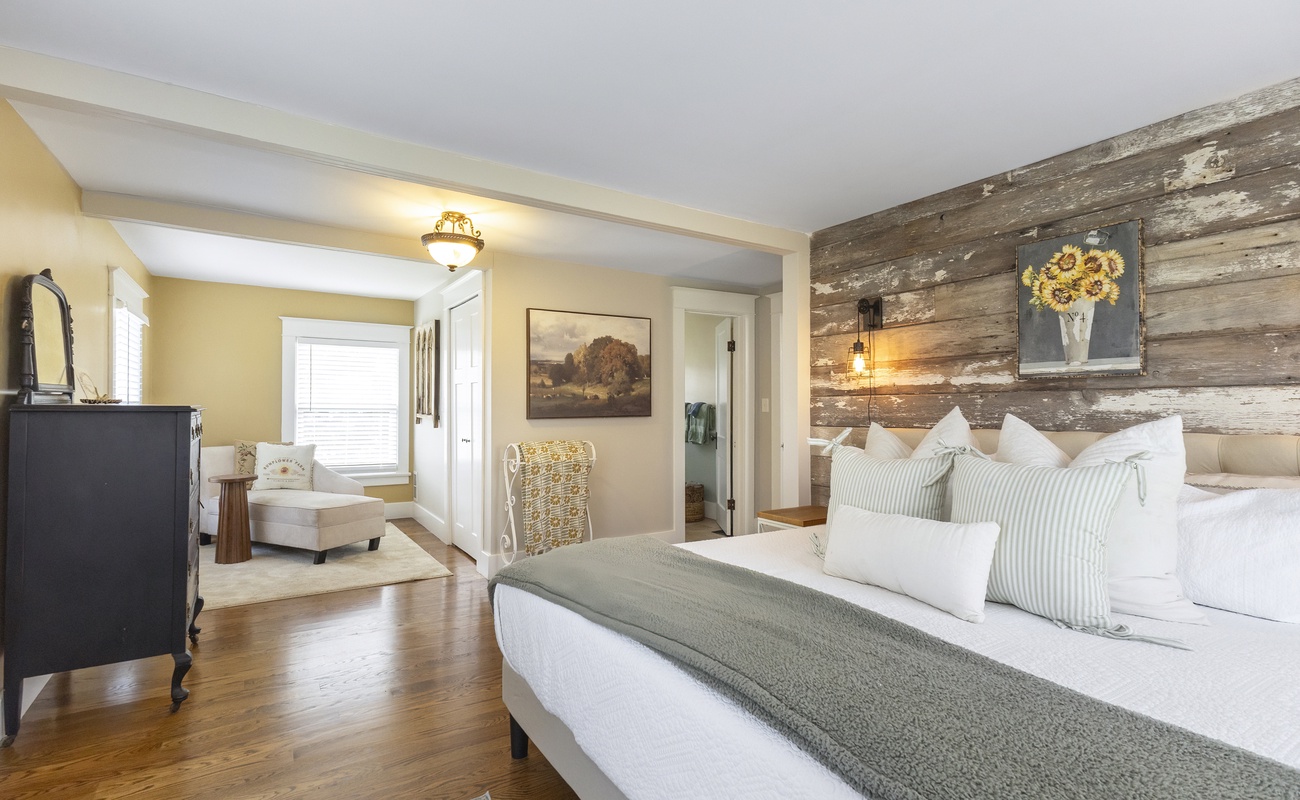 The primary bedroom is on the upper level & has a king-size bed and a daybed.