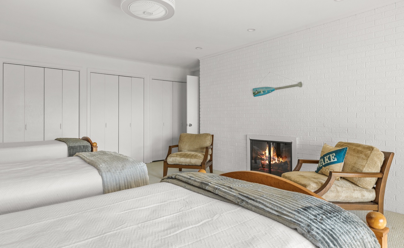 Posh bedroom with a fireplace, lavish decor, plenty of storage space. We likey!
