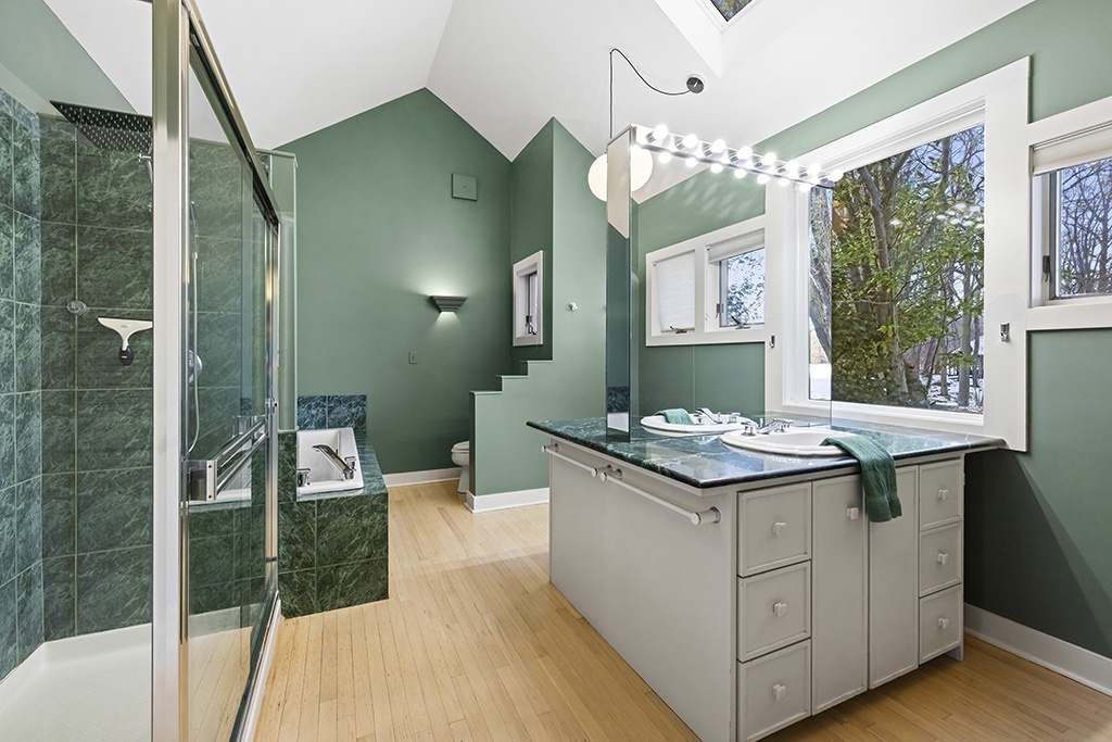 An open, light-filled retreat with dual sinks and a luxe soaking tub.