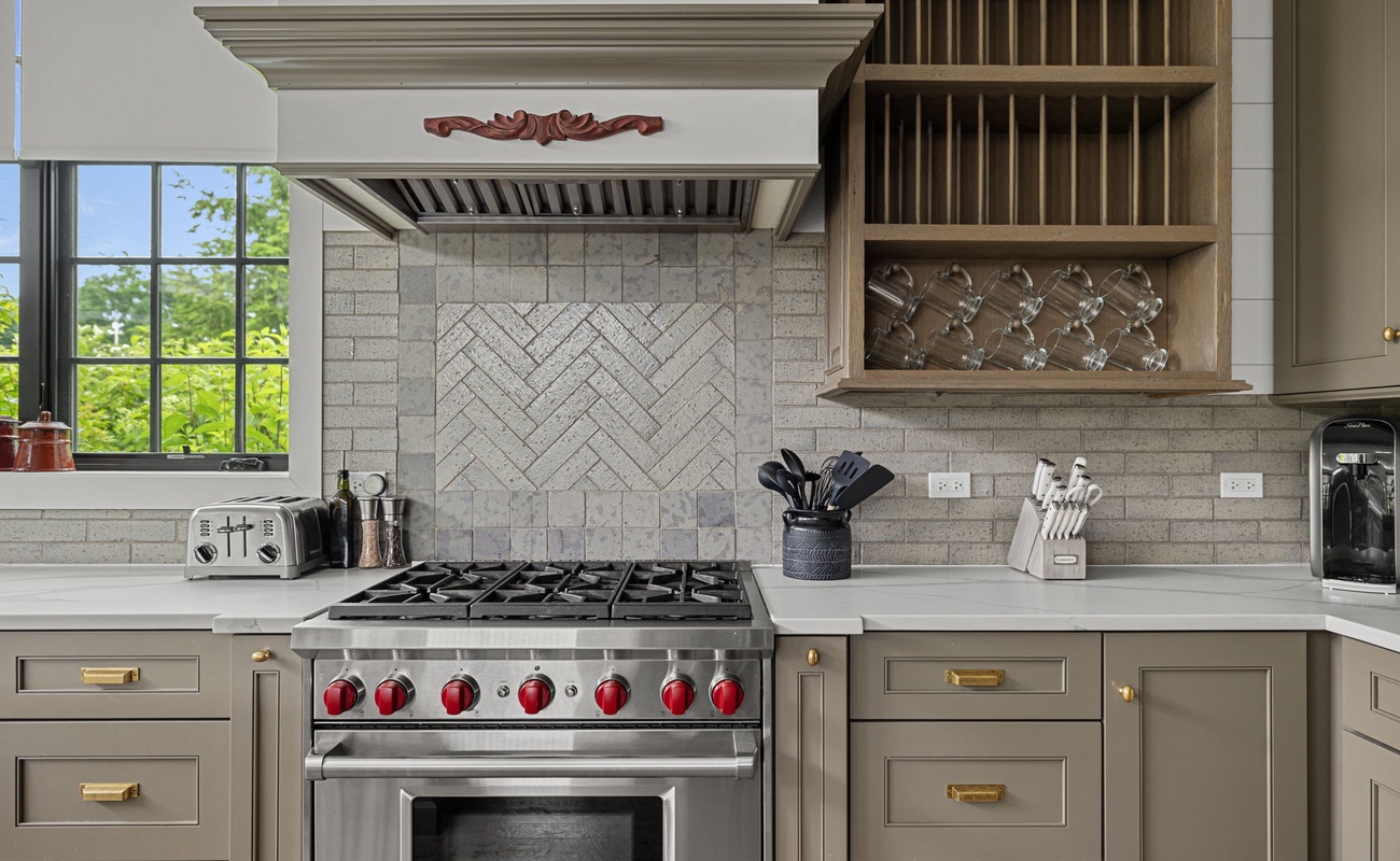 High-end appliances anchor this stunning chef’s kitchen.