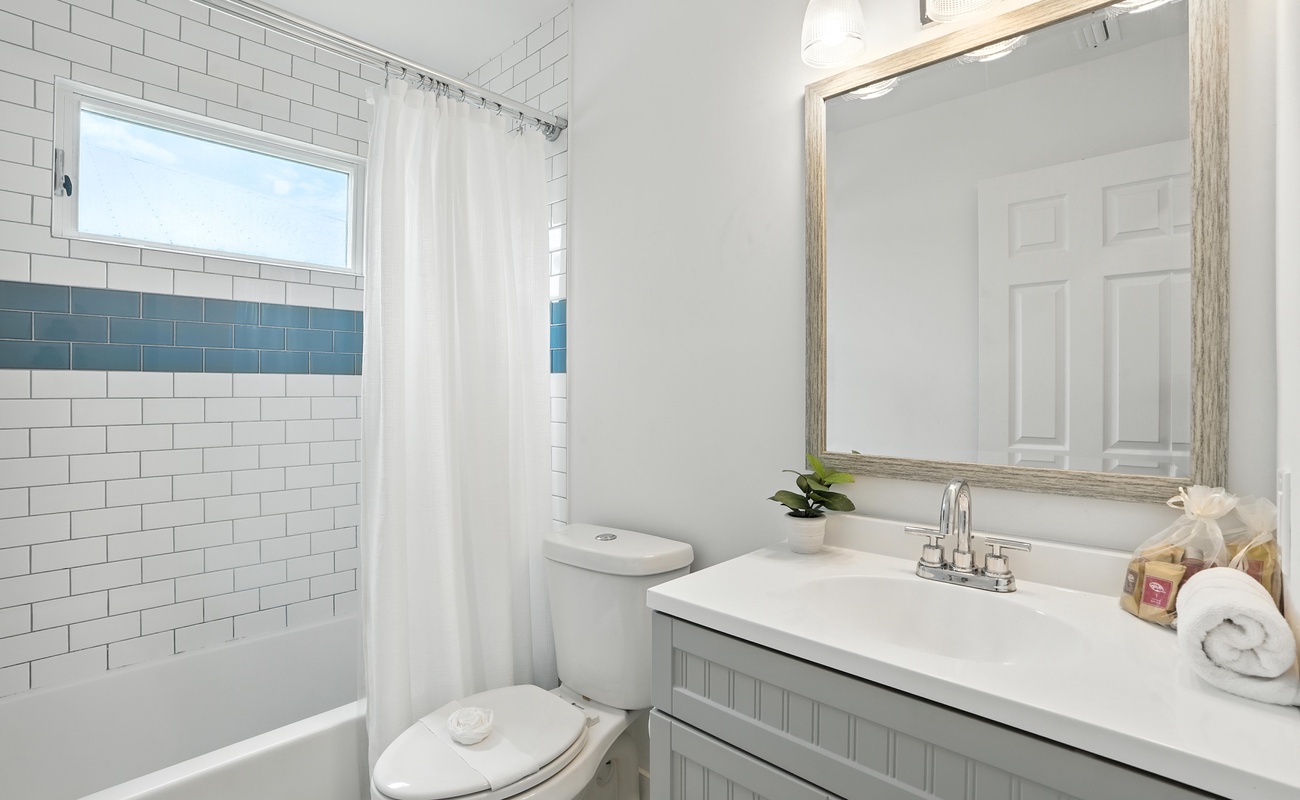 Bright bathroom with subway tile, ocean hues, and modern finishes.