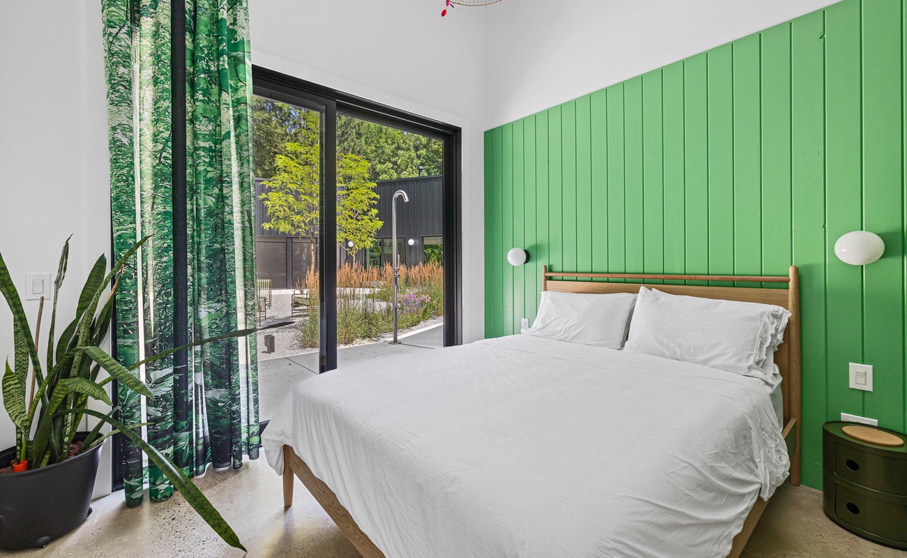 Bedroom 1 has a queen-size bed & courtyard access.