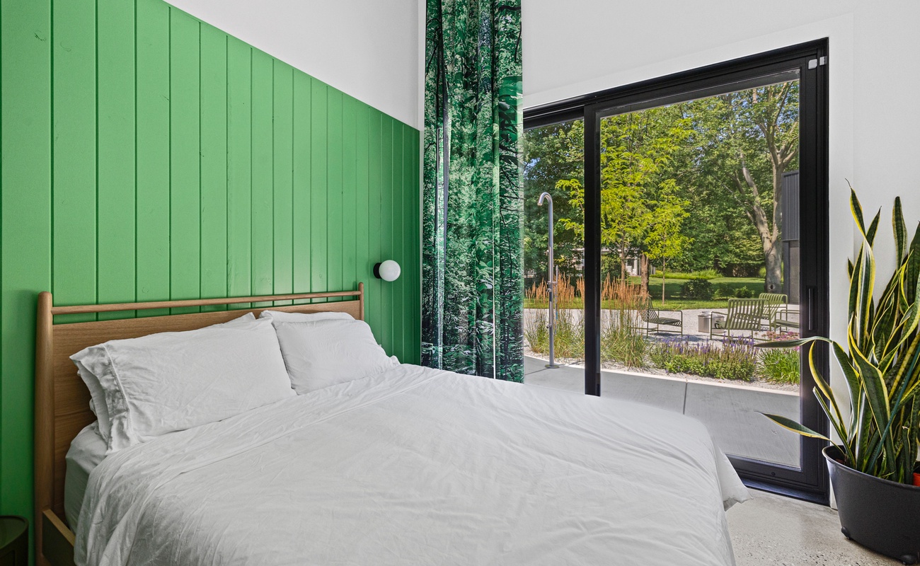 Bedroom 2 has a queen-size bed and courtyard access.