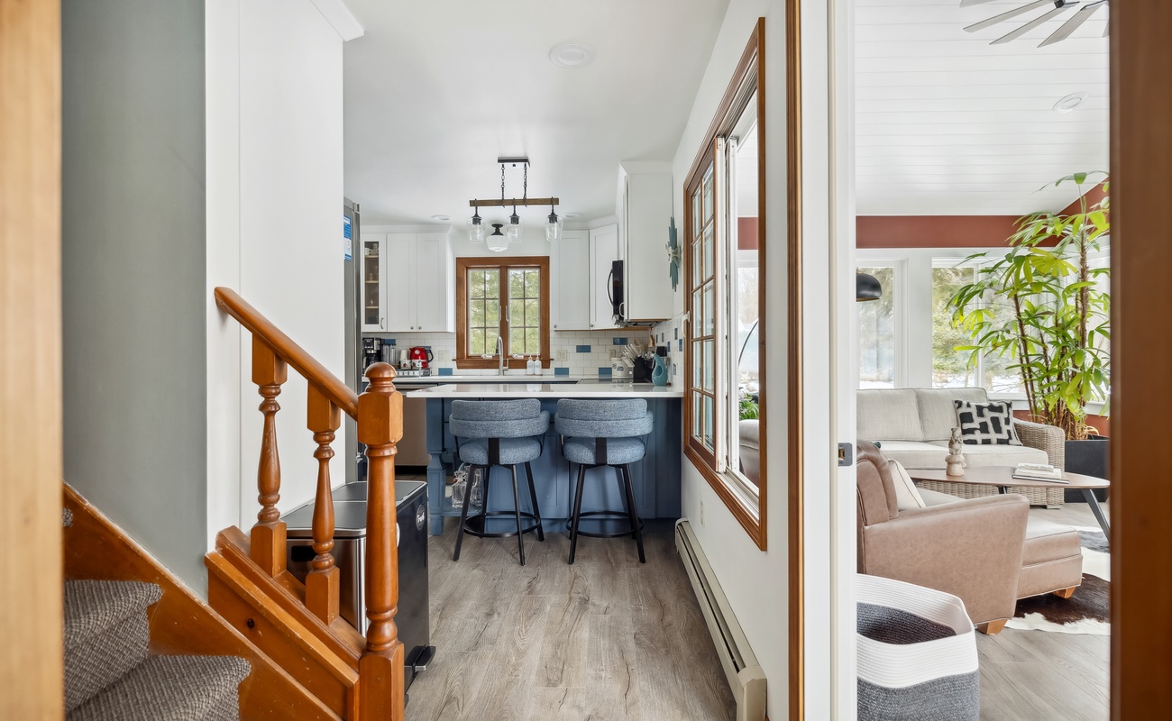 Peek inside: a kitchen built for conversation, a sunroom built for relaxation, and a staircase built for dramatic exits.