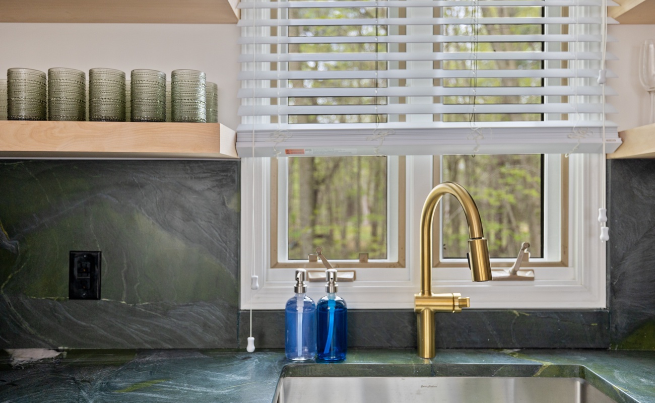 Create delicious meals in our modern kitchen with gorgeous black-and-green quartzite counters.