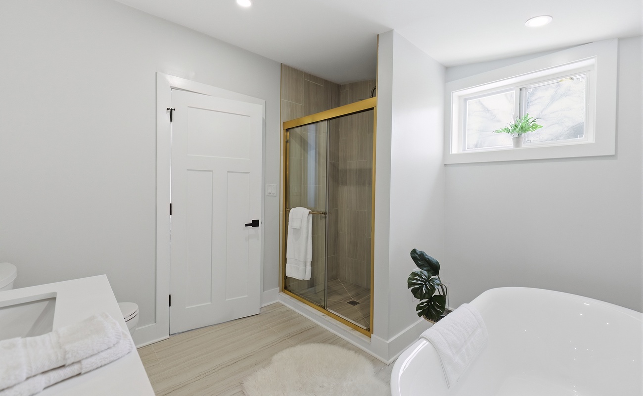 The primary bath pairs a soaking tub with a spacious shower.