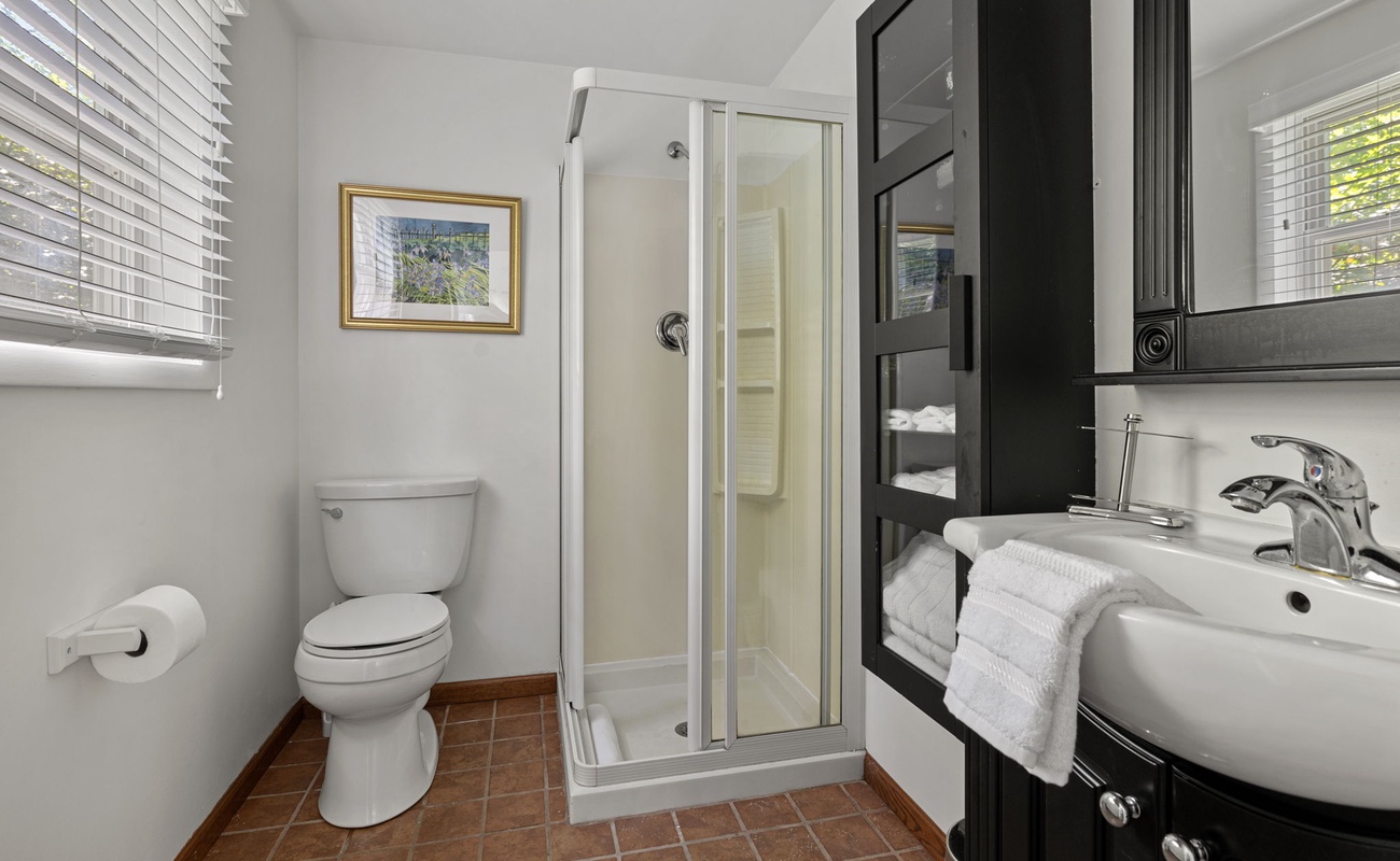 Compact and chic—this bathroom packs in all the essentials with style and light to spare.