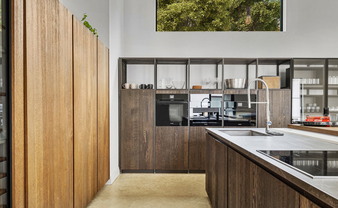 Your gourmet kitchen features sleek wood cabinetry and modern appliances, perfect for preparing memorable meals during your stay.