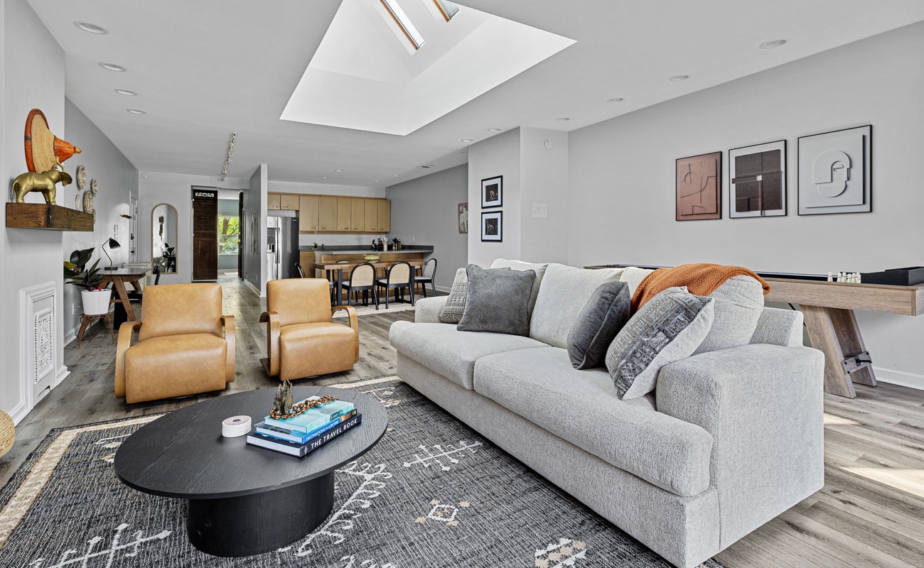 Basking in the natural glow of the skylight, cozied up on this comfy couch. Perfect spot for some quality 'me' time!